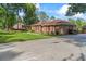 Beautiful brick home features a well-manicured lawn and lush landscaping creating a serene environment at 1551 Hutton Pl, Charleston, SC 29407
