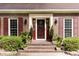 Elegant front entrance with brick steps, decorative plants, and a stylish door with sidelights at 1551 Hutton Pl, Charleston, SC 29407