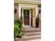 Charming front porch with brick steps and decorative plants leading to a stylish front door at 1551 Hutton Pl, Charleston, SC 29407