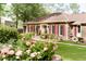 Quaint brick home with charming landscaping and manicured lawn provides curb appeal at 1551 Hutton Pl, Charleston, SC 29407