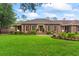 Charming brick home with manicured lawn, red shutters, and mature landscaping provides curb appeal at 1551 Hutton Pl, Charleston, SC 29407