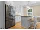 Modern kitchen with stainless steel refrigerator, white cabinetry and a central island at 1551 Hutton Pl, Charleston, SC 29407
