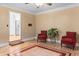 Living room with hardwood floors, decorative chairs, and an open doorway to the kitchen at 1551 Hutton Pl, Charleston, SC 29407