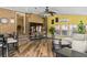 Bright living room with a brick wall, mounted tv, and access to a sunroom with many windows at 1551 Hutton Pl, Charleston, SC 29407