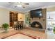 Cozy living room with a brick fireplace, built-in shelving, and hardwood floors at 1551 Hutton Pl, Charleston, SC 29407