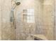 Shower featuring gray tiling, built-in shelves, and a modern showerhead with clear glass door at 1551 Hutton Pl, Charleston, SC 29407
