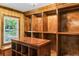 Large walk-in closet featuring custom wood shelving, center island with dresser and chandelier at 1551 Hutton Pl, Charleston, SC 29407