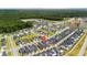 Aerial view of a Primary-planned community with mature trees, serene pond, and a pin on one of the houses at 1963 Longhorn Ln, Summerville, SC 29485