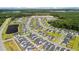 Aerial view of a Primary-planned community with mature trees and serene pond at 1963 Longhorn Ln, Summerville, SC 29485