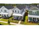 Aerial view of a charming two-story home with a well-manicured lawn, an American flag, and a welcoming front porch at 1963 Longhorn Ln, Summerville, SC 29485