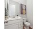 Stylish powder room with modern fixtures, white cabinetry, and elegant decor at 1963 Longhorn Ln, Summerville, SC 29485