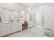 Bright bathroom features double vanity with white countertops, a window, and marble flooring at 1963 Longhorn Ln, Summerville, SC 29485