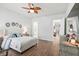 Elegant main bedroom featuring wood floors, a white bed, and a decorative ceiling fan at 1963 Longhorn Ln, Summerville, SC 29485