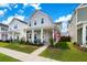 Inviting two-story home with a quaint front porch, surrounded by lush green lawn and beautiful landscaping at 1963 Longhorn Ln, Summerville, SC 29485