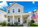 Charming home with a classic front porch featuring rocking chairs and an American flag at 1963 Longhorn Ln, Summerville, SC 29485