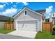 View of a detached garage featuring white siding, a white door, and a wooden fence at 1963 Longhorn Ln, Summerville, SC 29485