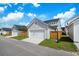 View of a detached garage featuring white siding, a white door, and a wooden fence at 1963 Longhorn Ln, Summerville, SC 29485