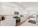 The kitchen has white cabinets, stainless appliances, and a view of the dining area at 1963 Longhorn Ln, Summerville, SC 29485