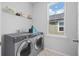 Well-equipped laundry room featuring modern washer/dryer and natural light at 1963 Longhorn Ln, Summerville, SC 29485