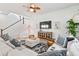Bright and airy living room features a staircase, TV, and a comfortable sectional sofa at 1963 Longhorn Ln, Summerville, SC 29485