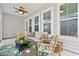 Relaxing covered patio featuring comfortable seating and outdoor ceiling fan at 1963 Longhorn Ln, Summerville, SC 29485