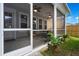 Exterior view of a screened-in porch featuring wicker furniture, ceiling fans and direct access to the backyard at 1963 Longhorn Ln, Summerville, SC 29485