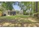Well-maintained backyard with lush grass, mature trees, and landscaping at 2136 Kings Gate Ln, Mount Pleasant, SC 29466