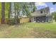 Spacious backyard with lawn, trees, and a wooden fence enhancing privacy at 2136 Kings Gate Ln, Mount Pleasant, SC 29466