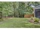 Landscaped backyard featuring lawn, mature trees, and a wooden fence at 2136 Kings Gate Ln, Mount Pleasant, SC 29466