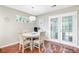Dining area with French doors and light fixture has seating for four at 2136 Kings Gate Ln, Mount Pleasant, SC 29466