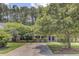Charming single Gathering home with a well maintained front yard, mature trees, and a long driveway at 2136 Kings Gate Ln, Mount Pleasant, SC 29466