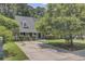 Charming single Gathering home with a well maintained front yard, mature trees, and a long driveway at 2136 Kings Gate Ln, Mount Pleasant, SC 29466