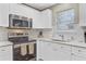 A closer look at the white kitchen cabinets, stainless steel appliances and subway tile backsplash at 2136 Kings Gate Ln, Mount Pleasant, SC 29466