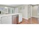 Kitchen view features stainless dishwasher, white cabinets and stone countertops with hardwood floors at 2136 Kings Gate Ln, Mount Pleasant, SC 29466