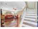 Open concept living room has beautiful hardwood floors and stairway access at 2136 Kings Gate Ln, Mount Pleasant, SC 29466