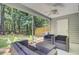 Screened patio with seating area and fan overlooking the lush backyard at 2136 Kings Gate Ln, Mount Pleasant, SC 29466