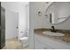 Powder room with granite countertop and round decorative mirror at 2258 Arthur Gaillard Ln, Charleston, SC 29414