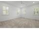 Bright, spacious bedroom with three windows featuring plantation shutters and neutral carpet at 2258 Arthur Gaillard Ln, Charleston, SC 29414