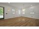 Elegant dining space featuring hardwood floors, custom wall details, and contemporary lighting, adjacent to an exterior door at 2258 Arthur Gaillard Ln, Charleston, SC 29414