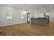 Bright dining area open to the kitchen, featuring hardwood floors, modern lighting, and stylish white and gray accents at 2258 Arthur Gaillard Ln, Charleston, SC 29414
