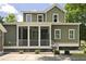 Two story home with green exterior, screened in porch, and concrete driveway at 2258 Arthur Gaillard Ln, Charleston, SC 29414