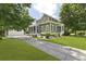 Two-story home with lush landscaping, long driveway, and detached garage at 2258 Arthur Gaillard Ln, Charleston, SC 29414