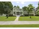 Inviting home showcasing lush landscaping, a green lawn, and a charming porch, creating a warm and welcoming ambiance at 2258 Arthur Gaillard Ln, Charleston, SC 29414