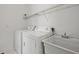Bright laundry room with washer, dryer, utility sink and wire rack shelving above at 2258 Arthur Gaillard Ln, Charleston, SC 29414