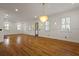 Spacious living room filled with natural light, featuring hardwood floors and elegant chandelier lighting at 2258 Arthur Gaillard Ln, Charleston, SC 29414