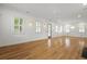 Bright, spacious living room featuring hardwood floors and ample natural light from large windows with stylish shutters at 2258 Arthur Gaillard Ln, Charleston, SC 29414