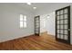 Bright living room with hardwood floors, plantation shutters and glass panel doors to an adjoining room at 2258 Arthur Gaillard Ln, Charleston, SC 29414