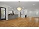 Bright open-concept living space featuring hardwood floors, modern lighting, and a cozy fireplace at 2258 Arthur Gaillard Ln, Charleston, SC 29414