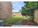 Spacious backyard featuring a privacy fence, mature trees, and green grass; perfect for outdoor activities at 2362 Parsonage Rd # 2H, Charleston, SC 29414