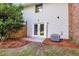 Backyard featuring a grassy lawn, exterior siding, brick and a view of double doors at 2362 Parsonage Rd # 2H, Charleston, SC 29414